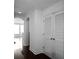 Hallway featuring hardwood floors, arched doorways, and closet space at 3445 Stratford Ne Rd # 1101, Atlanta, GA 30326