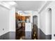 Open-concept living room with hardwood floors, kitchen view, and arched doorways at 3445 Stratford Ne Rd # 1101, Atlanta, GA 30326