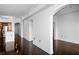 Open-concept living room with hardwood floors, kitchen view, and architectural columns at 3445 Stratford Ne Rd # 1101, Atlanta, GA 30326