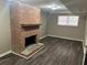 Basement with a brick fireplace, wood mantle, vinyl floors, and a window with blinds at 6625 Paula Ct, Lithonia, GA 30038