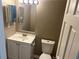 Clean bathroom with a large mirror, white vanity, toilet, and great lighting at 6625 Paula Ct, Lithonia, GA 30038