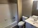Full bathroom with white tiled walls, modern fixtures, and an updated vanity at 6625 Paula Ct, Lithonia, GA 30038