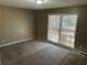Another cozy bedroom featuring plush carpet and natural light from the window at 6625 Paula Ct, Lithonia, GA 30038