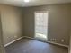 This bedroom features neutral colors, soft carpeting, and a window, perfect for a peaceful retreat at 6625 Paula Ct, Lithonia, GA 30038
