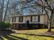 Split-level home featuring a brick foundation, front porch, and an inviting facade in a wooded neighborhood at 6625 Paula Ct, Lithonia, GA 30038
