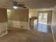 Open-concept living room and dining area leading to the kitchen, perfect for entertaining guests at 6625 Paula Ct, Lithonia, GA 30038