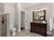 Well-lit bathroom featuring a dark wood vanity with granite countertop and a tiled walk-in shower at 1244 Kingsley Ne Cir, Atlanta, GA 30324