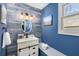 Charming bathroom featuring wood plank accent wall, modern vanity, and a stylish oval mirror at 1244 Kingsley Ne Cir, Atlanta, GA 30324