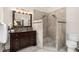 Bathroom featuring double shower heads, tiled walls, dark wood vanity and large mirror at 1244 Kingsley Ne Cir, Atlanta, GA 30324