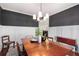 Elegant dining room with dark accent wall, wainscoting, and modern lighting fixture at 1244 Kingsley Ne Cir, Atlanta, GA 30324