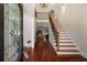 Grand entryway with gleaming hardwood floors, a statement chandelier, and an elegant staircase leading to the upper level at 1244 Kingsley Ne Cir, Atlanta, GA 30324