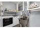 Functional laundry room with modern washer and dryer, utility sink, and storage shelves at 1244 Kingsley Ne Cir, Atlanta, GA 30324