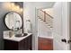 Stylish powder room with a vessel sink, marble backsplash, and modern lighting, conveniently located near the staircase at 1244 Kingsley Ne Cir, Atlanta, GA 30324