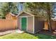 Outdoor shed with green door, painted siding, and practical yard storage at 1244 Kingsley Ne Cir, Atlanta, GA 30324