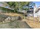 View of the fenced backyard with a wooden retaining wall and a deck at 1325 Richland Creek Ct, Buford, GA 30518