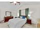 Vaulted ceiling bedroom with neutral color scheme, ceiling fan, and comfortable queen bed at 1325 Richland Creek Ct, Buford, GA 30518