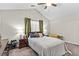 Vaulted ceiling bedroom with neutral color scheme, ceiling fan, and comfortable queen bed at 1325 Richland Creek Ct, Buford, GA 30518