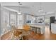 Open concept dining area with natural light, table seating, and a view into the kitchen at 1325 Richland Creek Ct, Buford, GA 30518