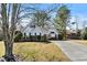 Inviting single-Gathering home featuring meticulous landscaping, a long driveway, and mature trees at 1325 Richland Creek Ct, Buford, GA 30518