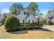 Quaint, single Gathering home featuring light gray siding and manicured landscaping with lush green bushes at 1325 Richland Creek Ct, Buford, GA 30518