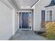 Home's entrance features a dark front door with sidelights, 'Welcome' sign, and attached garage at 1325 Richland Creek Ct, Buford, GA 30518