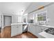 Bright kitchen with stainless steel appliances, white cabinets and hardwood floors at 1325 Richland Creek Ct, Buford, GA 30518