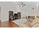 Open-concept living room featuring a vaulted ceiling, ceiling fan, fireplace, and hardwood floors at 1325 Richland Creek Ct, Buford, GA 30518