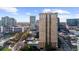 Aerial shot of an elegant building with a pool and tennis court, surrounded by the urban landscape at 325 E Paces Ferry Ne Rd # 504, Atlanta, GA 30305