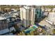 Aerial view showcasing the building, pool, and tennis court amenities amidst city surroundings at 325 E Paces Ferry Ne Rd # 504, Atlanta, GA 30305