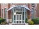 Stunning entrance to the Paces 325 building featuring brick and grand glass doors at 325 E Paces Ferry Ne Rd # 504, Atlanta, GA 30305
