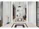 Elegant hallway with marble floors, white pillars and modern pendant lighting at 325 E Paces Ferry Ne Rd # 504, Atlanta, GA 30305