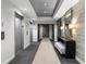 Hallway view showing elevators and entry with decorative lighting, a mirror, and a patterned bench at 325 E Paces Ferry Ne Rd # 504, Atlanta, GA 30305