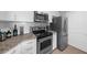 Modern kitchen featuring stainless steel appliances, white cabinetry and marble countertops at 325 E Paces Ferry Ne Rd # 504, Atlanta, GA 30305