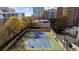 Aerial view of a well-maintained outdoor tennis court with city views in the background at 325 E Paces Ferry Ne Rd # 504, Atlanta, GA 30305