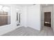 Bedroom with light-colored carpet, a window and door to the outside, and a hallway at 338 Olmstead Way # 35, Alpharetta, GA 30022