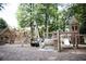 Community playground with a rustic wooden playset among mature trees in a serene outdoor setting at 338 Olmstead Way # 35, Alpharetta, GA 30022