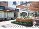 Outdoor seating area at Rumi's Kitchen with wood pergola and decorative plants at 338 Olmstead Way # 35, Alpharetta, GA 30022