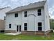 Backyard of a home with white siding, a small patio, and green lawn at 4375 Easter Lily Ave Lot 81, Buford, GA 30519