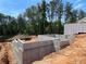 Image of a new home foundation with a concrete slab and framing set in a sunny outdoor location at 4375 Easter Lily Ave Lot 81, Buford, GA 30519