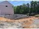 Image of a new home foundation with a concrete slab and framing set in a sunny outdoor location at 4375 Easter Lily Ave Lot 81, Buford, GA 30519