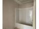 The white tiled bathroom features a tub-shower combination at 4375 Easter Lily Ave Lot 81, Buford, GA 30519