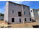 Exterior view of a home under construction, showing the framing, windows, and protective sheathing at 4375 Easter Lily Ave Lot 81, Buford, GA 30519