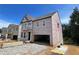 Exterior view of a home under construction, showing the framing, windows, and protective sheathing at 4375 Easter Lily Ave Lot 81, Buford, GA 30519