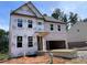 Exterior view of a home under construction, showing the framing, windows, and protective sheathing at 4375 Easter Lily Ave Lot 81, Buford, GA 30519