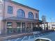 A brick building with arched windows has a covered porch, outdoor seating, and manicured flowers that gives a welcoming presence at 4375 Easter Lily Ave Lot 81, Buford, GA 30519