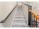 Carpeted staircase with stained handrail and black painted newel post and baseboard at 8819 Lakecrest Way, Union City, GA 30291