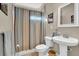 Bright bathroom featuring a pedestal sink, striped shower curtain, and neutral-toned walls at 1420 Orange Shoals Dr, Canton, GA 30115