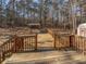 Large wooden back deck perfect for entertaining and relaxing in the forest at 230 Nina Cir, Locust Grove, GA 30248