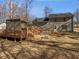 Spacious backyard featuring a large deck, fire pit, and mature trees at 230 Nina Cir, Locust Grove, GA 30248