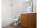 Neat bathroom includes a shower-tub combination and modern sink with wood-look cabinets at 230 Nina Cir, Locust Grove, GA 30248